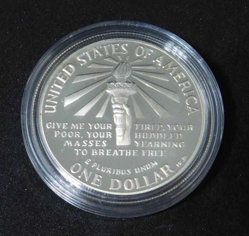 lot 30 image: 1986 S Ellis Island Mint State Commemorative Silver Dollar In Coin Capsule