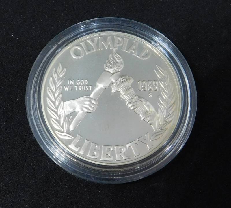 lot 32 image: 1988 S Olympiad Mint State Commemorative Silver Dollar In Coin Capsule