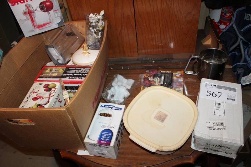 lot 567 image: Lot of Small Housewares - Including Coffee bean grinder, hand Blender, (2) Apple Peelers, Tupperware, and Ceramic containers