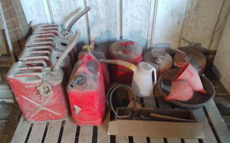 lot 34 image: Assorted Gas Cans, Tranny Fluid, Funnels, Oil & Other Automotive Chemicals In Cupboard