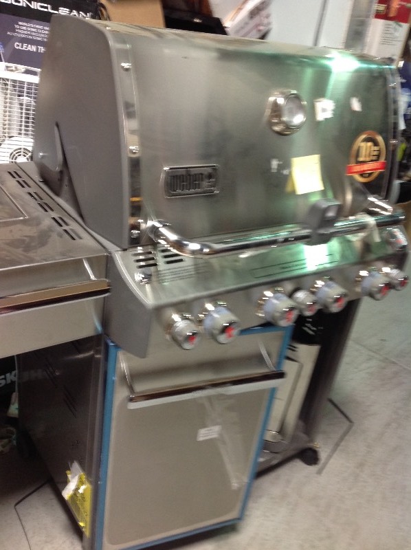 lot 105 image: Weber  Summit S-470 4-Burner Propane Gas Grill in Stainless Steel with Built-In Thermometer and Rotisserie DAMAGE  dents missing one door and one wheel  please review the photos stock photo used to display the unit