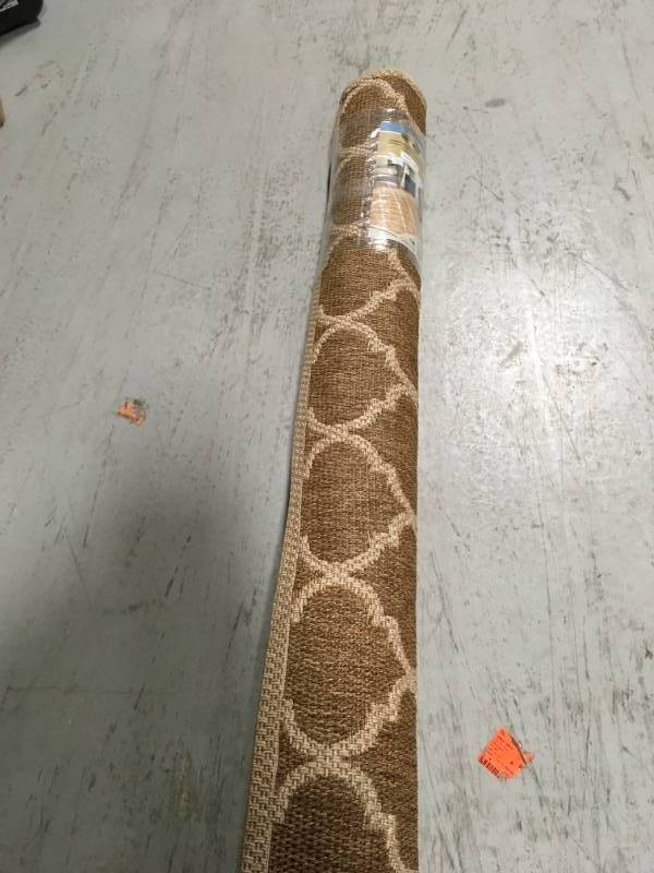 lot 71 image: Hampton Bay Trellis Tan Natural Sisal Flat Woven Weave 5 ft. x 7 ft. IndoorOutdoor Area Rug not used