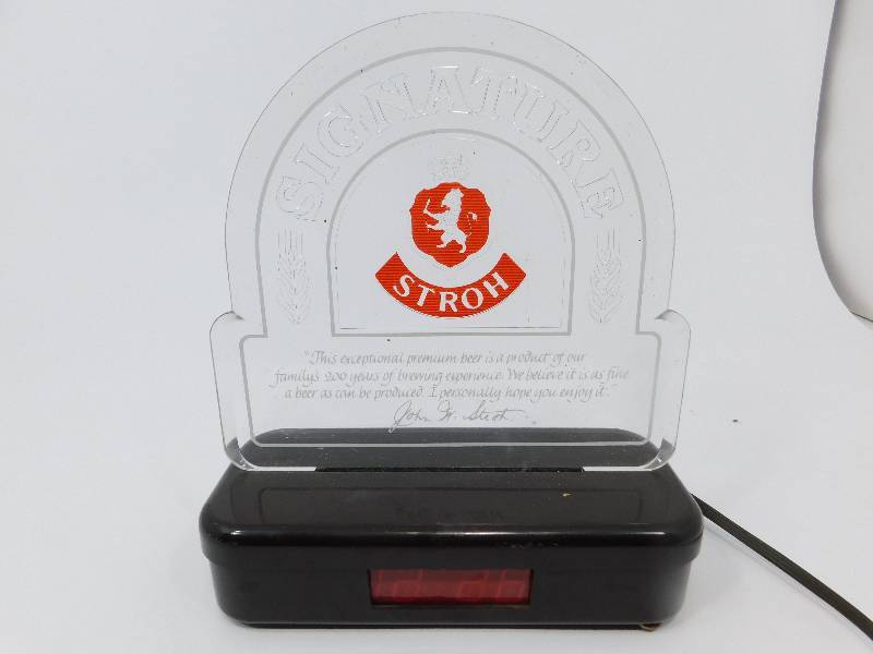 lot 14 image: Counter Signature Stroh Electric Clear Plastic Beer Sign W A Clock On The Base