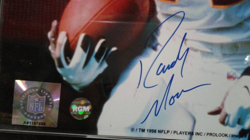 lot 1 image: Autographed Randy Moss Signed Photo On A Plaque, Has Signed COA With It, Plaque Has Slight Wear To It