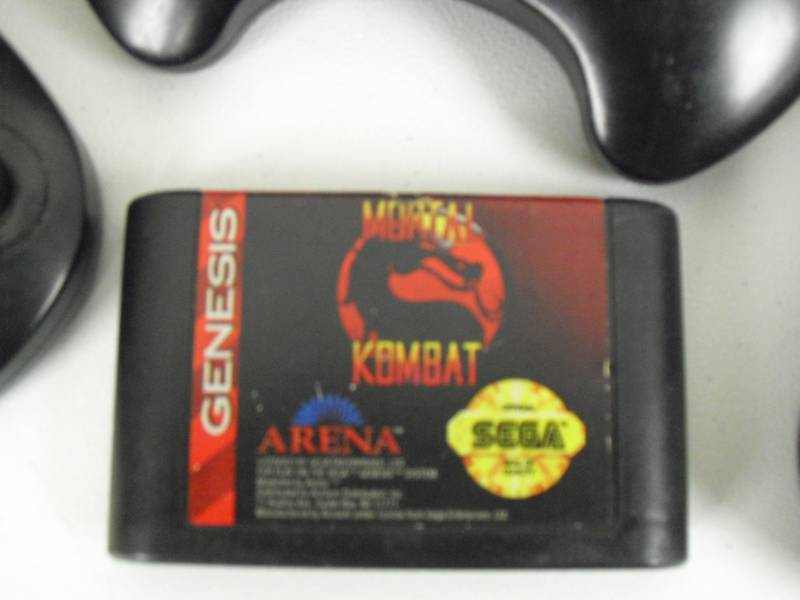 lot 84 image: Vintage Sega Genesis With Mortal Combat And Book