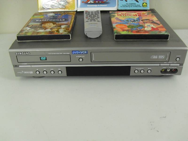 lot 158 image: Samsung VCRDVD Combo With Remote And School House Rock VHS And Disney DVDs