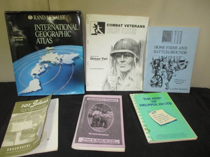 lot 24 image: Minnesota tomboy book, 100 successful farming ideas, combat veterans books and atlas