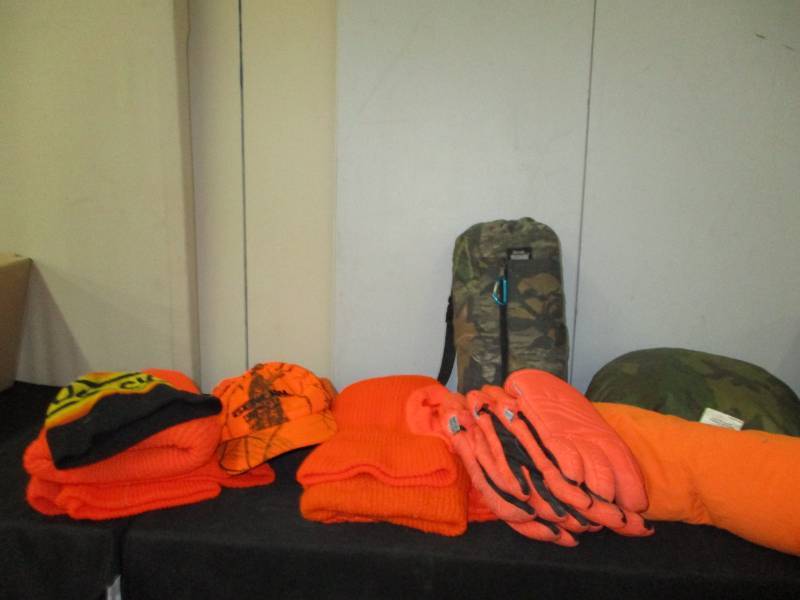 lot 41 image: Orange stocking hats, hand warmers, seat cusion and gloves