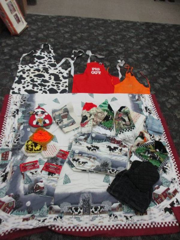 lot 49 image: LargeCow  Table Clothe with napkins, placemats and lots of cow towels, Aprons and potholders