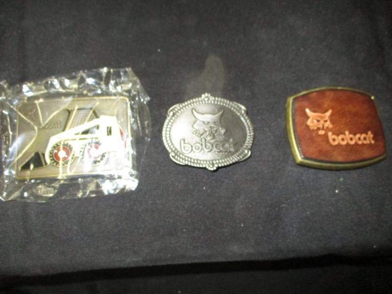 lot 151 image: 3 Bobcat belt buckles