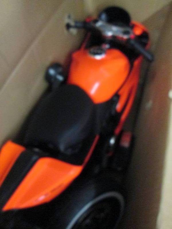 lot 181 image: Orange Motorbike with LED Lights op...