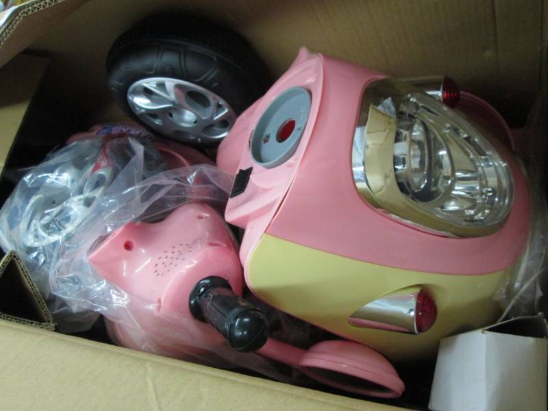 lot 194 image: Pink 3 Wheel Ride on, open box Asse...