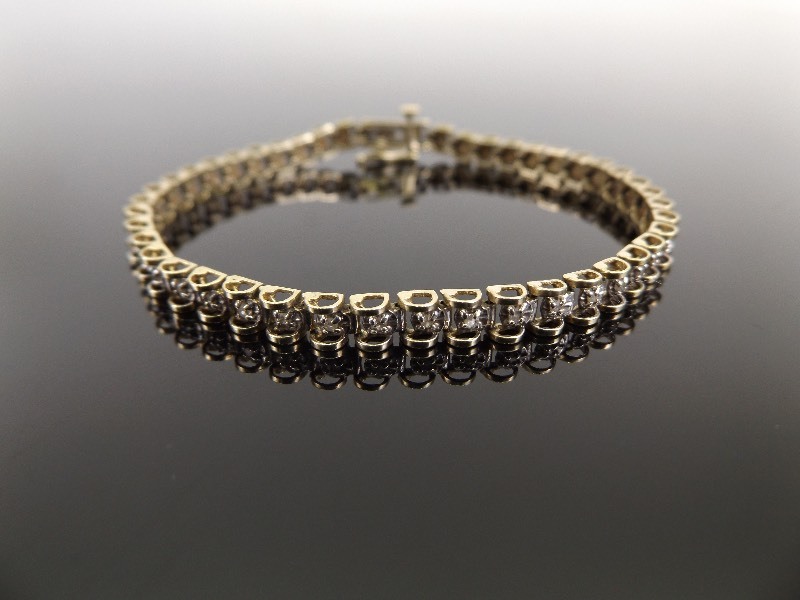 lot 33 image: 10k Yellow Gold Diamond Tennis Bracelet