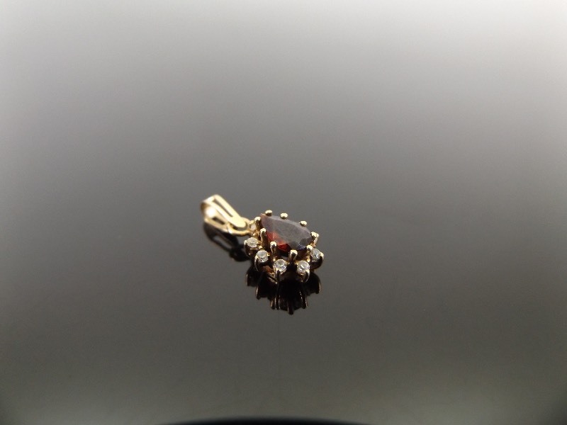 lot 32 image: 9k Yellow Gold Garnet and Diamond Accented Teardrop Pendant