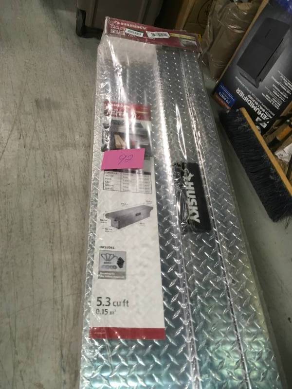 lot 92 image: Husky 71.3 in. x 13.8 in. x 15.7 in. Aluminum Full Size Low Profile Slim Saddle Truck Box in like new condition
