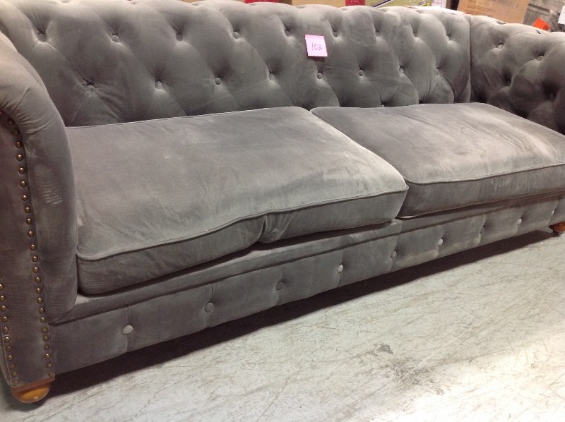 lot 102 image: Home Decorators Collection Gordon Grey Velvet Loveseat in good shape whit small hold in the back side and scratchs on the legs