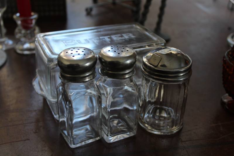 lot 446 image: Glass Butter Dish with Glass Cover, Glass Salt & Pepper Shakers with Stainless Shaker, Glass Sugar Shaker with Stainless Shaker