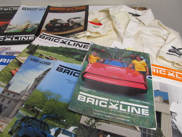 lot 93 image: Large Lot of Vintage Bric Line Magazine for BRICKLIN Sports Cars & Employee Shirt