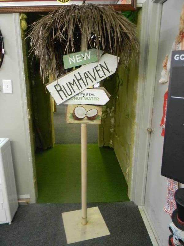 lot 7 image: RUM HAVEN DISPLAY - MADE WITH REAL COCONUT WATER - METAL STAND  BASE - COOL ITEM - APPROX 80 TALL - SEE PICTURES