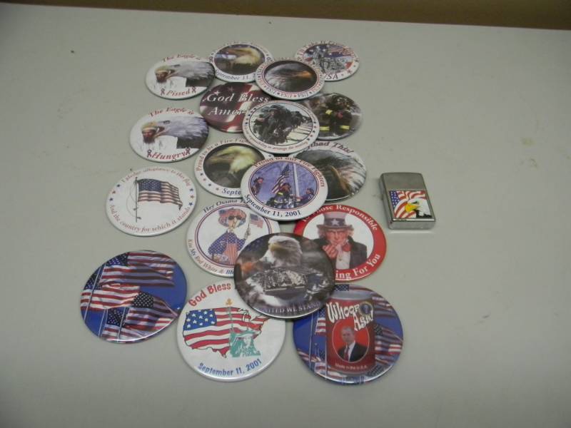 lot 43 image: COLLECTION OF SEPT. 11 2001 ORIGINAL BUTTONS & 1 PATRIOTIC NOS EAGLE FLAG ZIPPO LIGHTER - SEE PICTURES