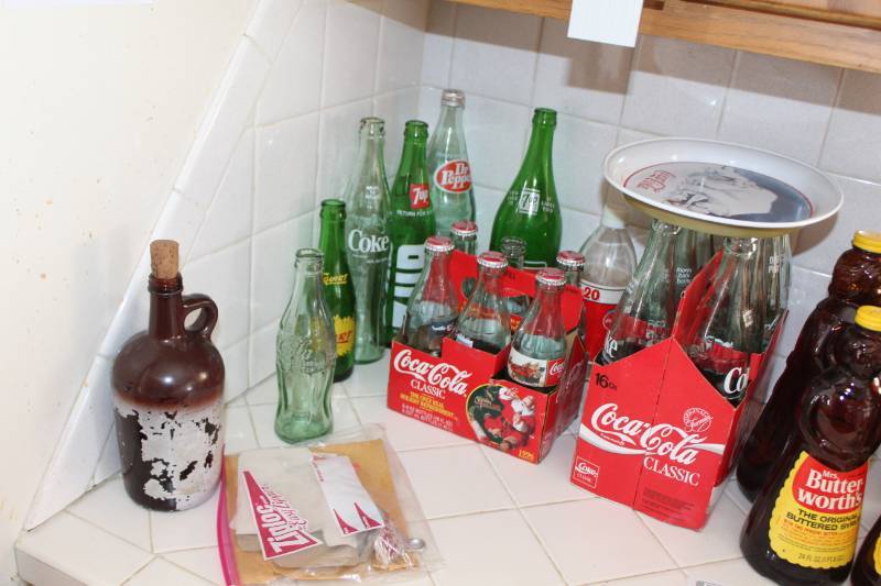 lot 83 image: Coca-Cola, Coke, 7-UP, Dr. Pepper Glass Pop Bottles, Coca-Cola Bottle Opener, Decorative Plate