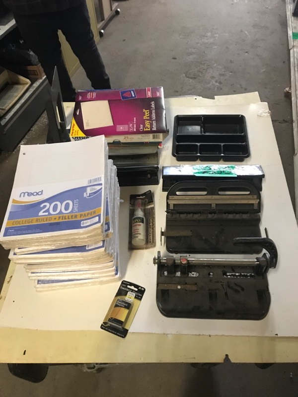 lot 250 image: Shelf of 14 packets of lined notebook paper (200packet), Five paper punches etc