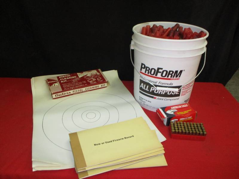 lot 12 image: Empty Cartridges and slugs, Pile of Targets, Gun Cleaning kit