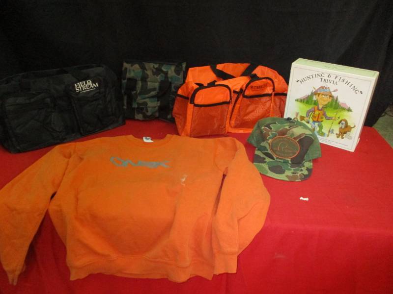 lot 19 image: Cammo Ducks Unlimited Cap, Cammo Cooler, Oeange Sweatshirt, Orange Outdoor Life Duffle bag, Field and Stream Bag, Hunting and Fishing Trivia Game
