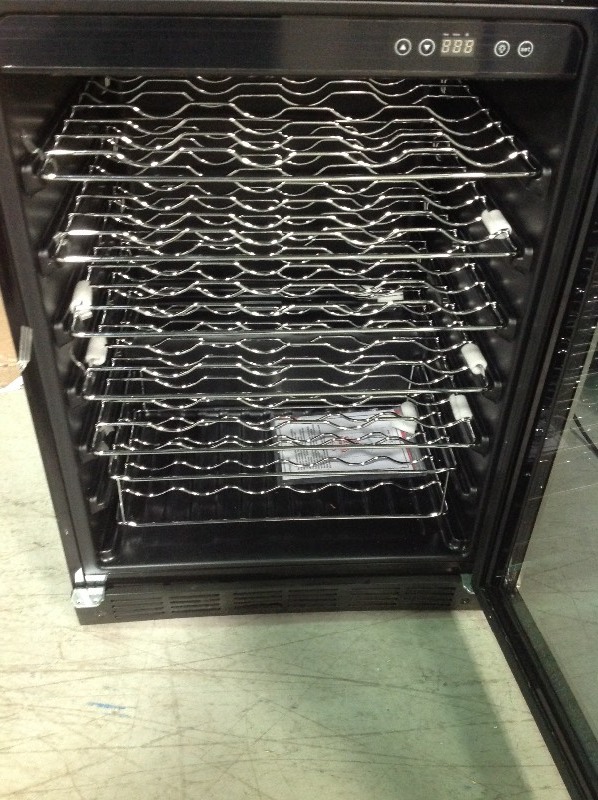 Magic Chef 23.4 in. W 50-Bottle Wine Cooler in Stainless Steel in working conditions have some scratches and dents
