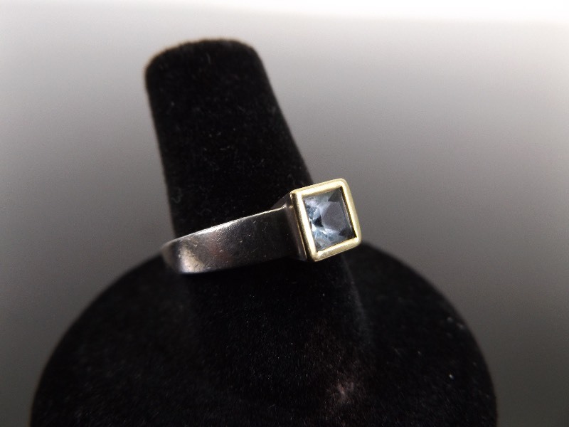 lot 8 image: .925 Sterling Silver Princess Cut Blue Topaz Ring Size 6.75