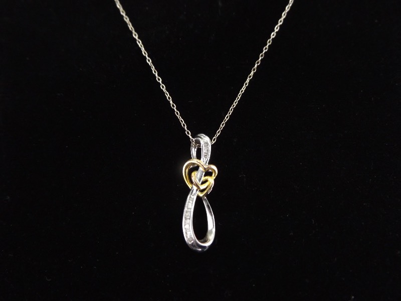 lot 51 image: .925 Sterling Silver Baguette Diamond Accented Heart Knot Pendant Necklace