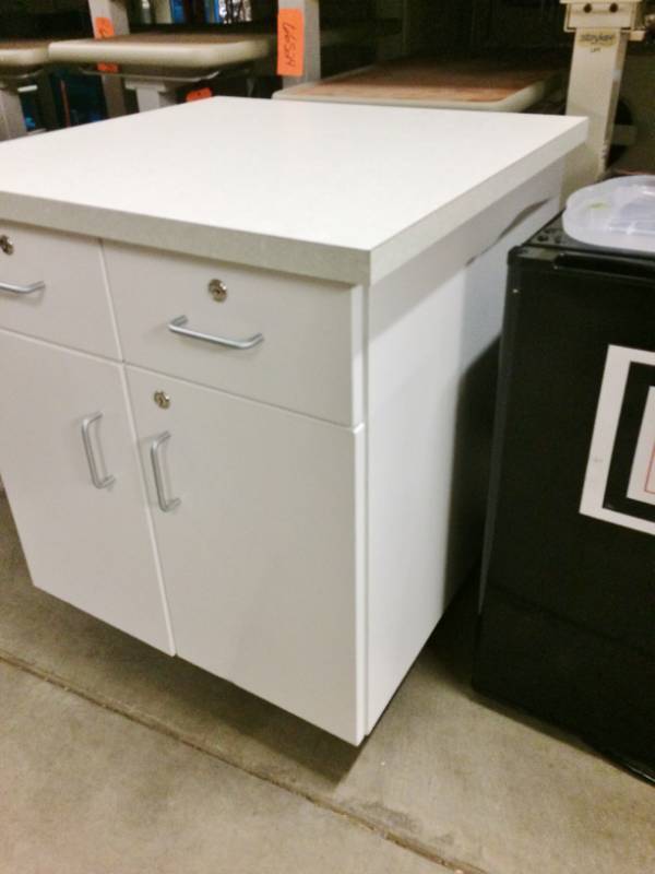 lot 51 image: 2 Door 2 Drawer Laminate Top Mobile Cabinet - 1 Wheel Wonky- Need To Be Reattached