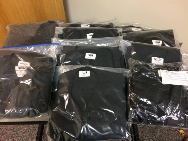 lot 126 image: Large Lot Of New Jostens Black Graduation Gowns - Variety Of Sizes Bachelor Degree Gowns Each Packaged Includes Cap - Two  Doctorate Gowns Included