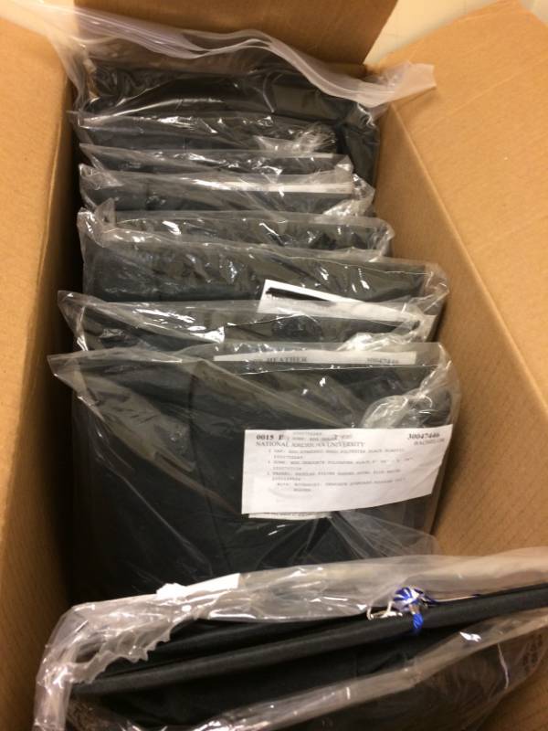 lot 129 image: Large Lot Of New Jostens Black Graduation Gowns - Variety Of Sizes Bachelor & Associate Degree Gowns Each Packaged Includes Cap