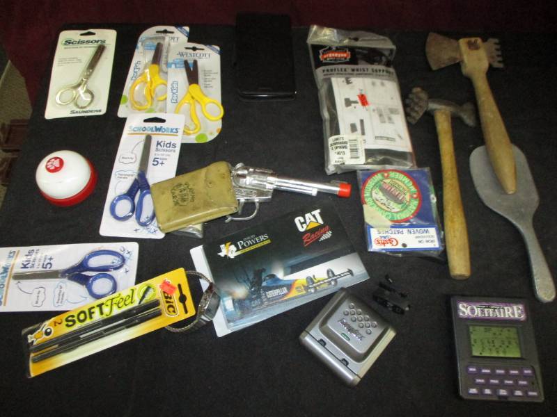 Toy gun, meet tenderizer, playing cards, blackjack games, siccors, bell and misc