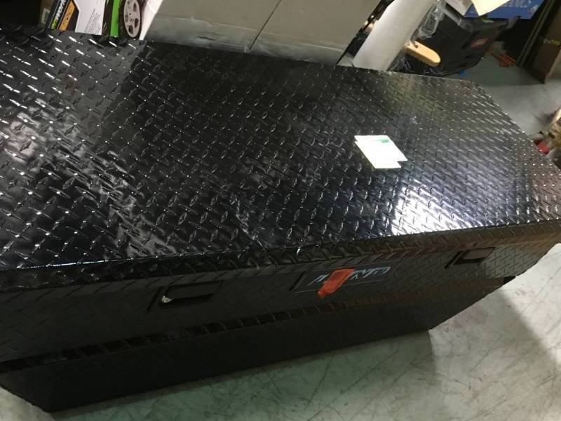 lot 99 image: Lund 63 in. Mid Size Single Lid Aluminum Beveled Low Profile Black Cross Bed Truck Tool Box in good condition
