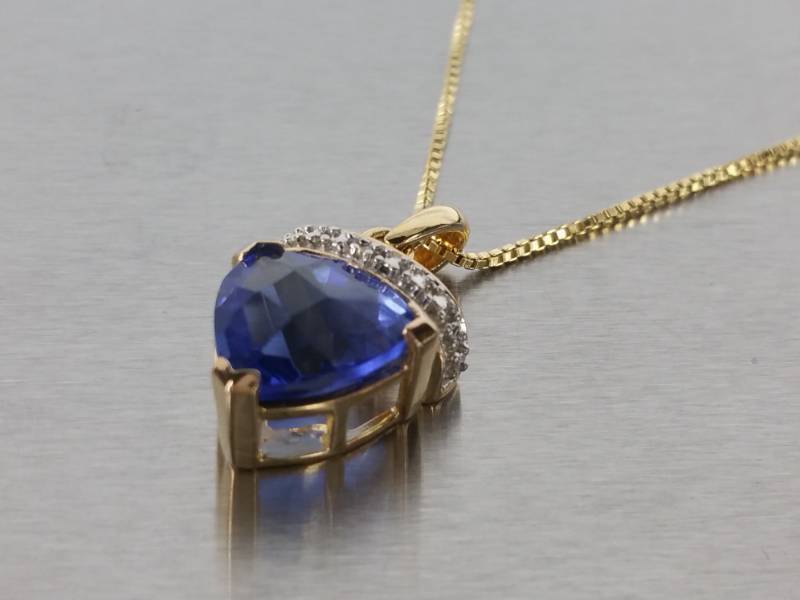 lot 72 image: Gorgeous Trillion Cut Blue Sapphire and Diamond Pendant and Chain in Sterling Silver