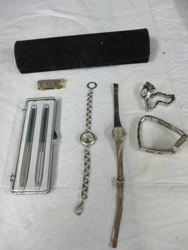 lot 43 image: Bunch of ladies watches, a pin and set of pens