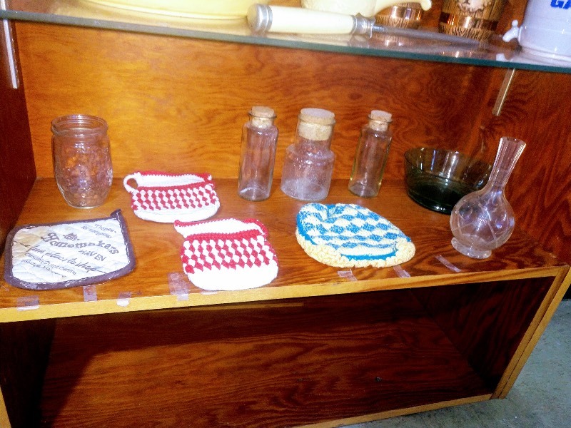 lot 37 image: Vintage Candle Holders - Peacock Mugs - Various Sized Glass Jars Vases - Oven Serve Bakers - Salt and Pepper Shakers - Dispenser Shaped Mug - Knife Sharpening Tool - Knives (2) - Potholders
