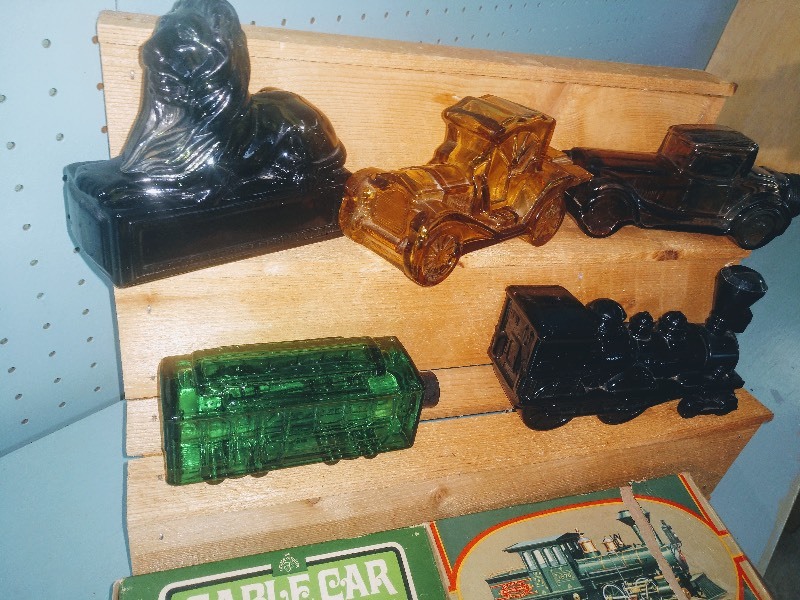 lot 99 image: Vintage Avon Wild Country After Shave - Cable Car Aftershave Lotion w Original Box - 1876 Centennial Express Decanter w Original Box - Classic Lion Aftershave - Sterling Six Aftershave Lotion