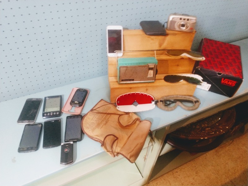 lot 101 image: Polaroid Goggle Kit with Nonpolarizing Lenses and Polarizing Anti-Glare Lenses - Pre-Owned Cell Phones and GPS - Emerson 911 Nevabreak 9 Transistor Pocket Radio - Bell Howell Z-200 Camera  and Black Carry Case - VANS Shoe Box