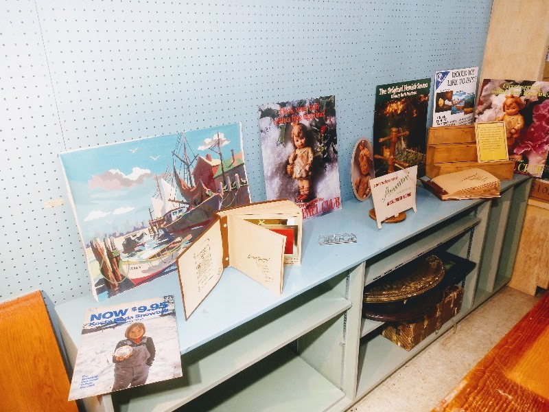 lot 107 image: Wooden Revolving Display - The Greeting Card Association Greeting Card Catalogues (2) - Canvas Print of Ann V. and Boats by a Dock - ORREFORS Figurine - ADVERTISING