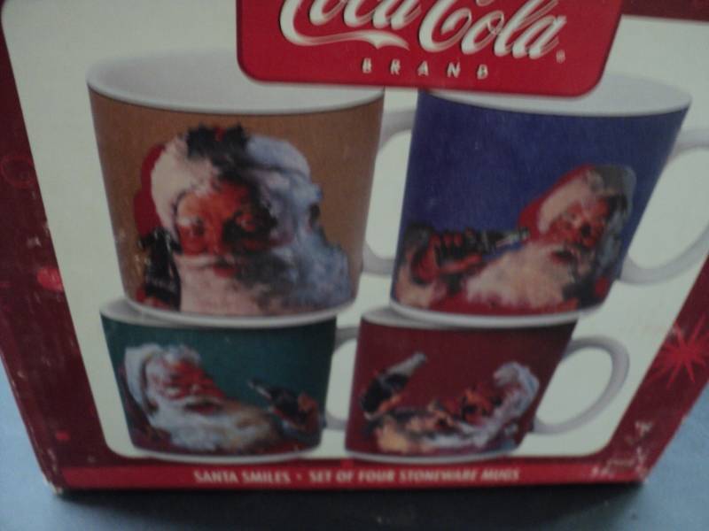 lot 109 image: Coca Cola set of 4 Santa Mugs...