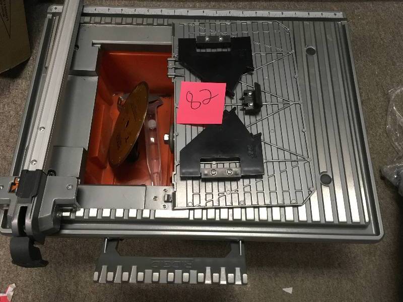lot 82 image: RIDGID 15 Amp Corded 10 in. Heavy-Duty Portable Table Saw not used