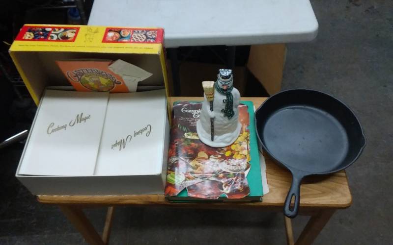lot 10 image: Cast Iron Skillet & Snow Man & Assorted Cook Books