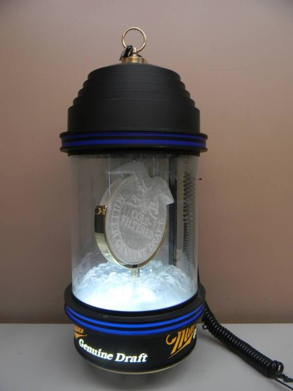 lot 18 image: VINTAGE HANGING ROTATING MGD BEER LIGHT - WORKS GREAT NICE - APPROX 12 BY 30 - SEE PICTURES