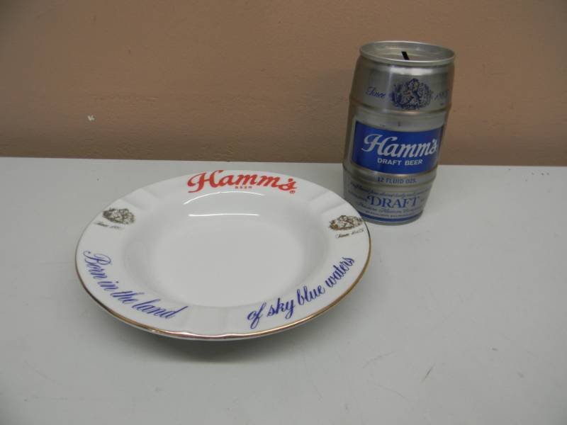 lot 32 image: Vintage Hamms Beer Porcelain Ashtray Born in the Land of Sky Blue Waters WVINTAGE HAMMS BEER CAN BANK - SEE PICTURES