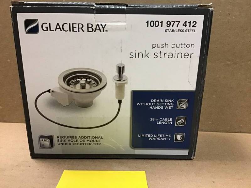 lot 41 image: Glacier Bay Strainer with Push Button Release Mechanism with Optional Brushed Nickel or Chrome Buttons in like new condition