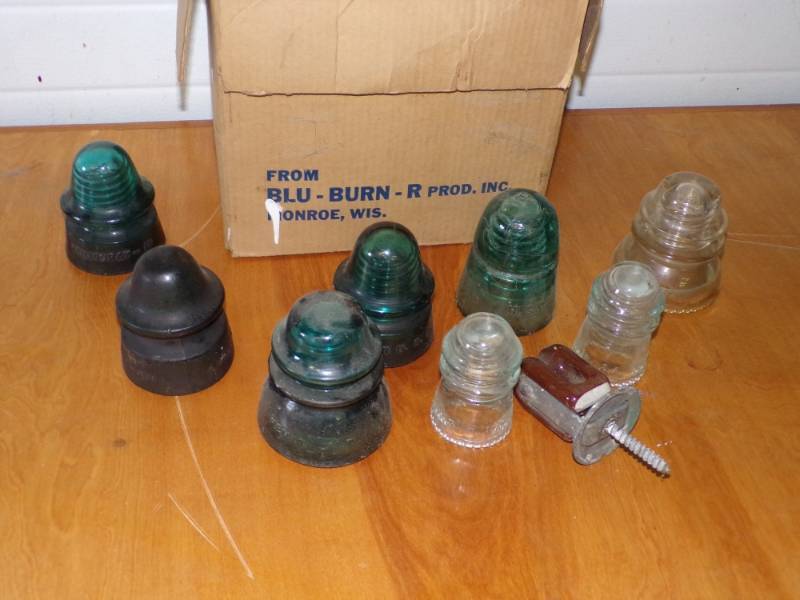 lot 14 image: Box full of Different Colored Insulators