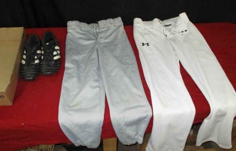 lot 93 image: cleets kids size 5 maybe cant see size and baseball pants size youth medium and Youth Large